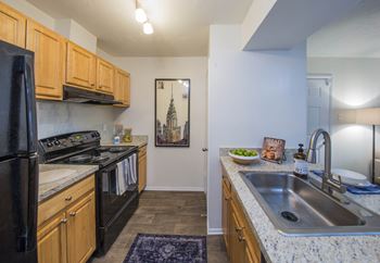 A kitchen with wood cabinets and black appliances